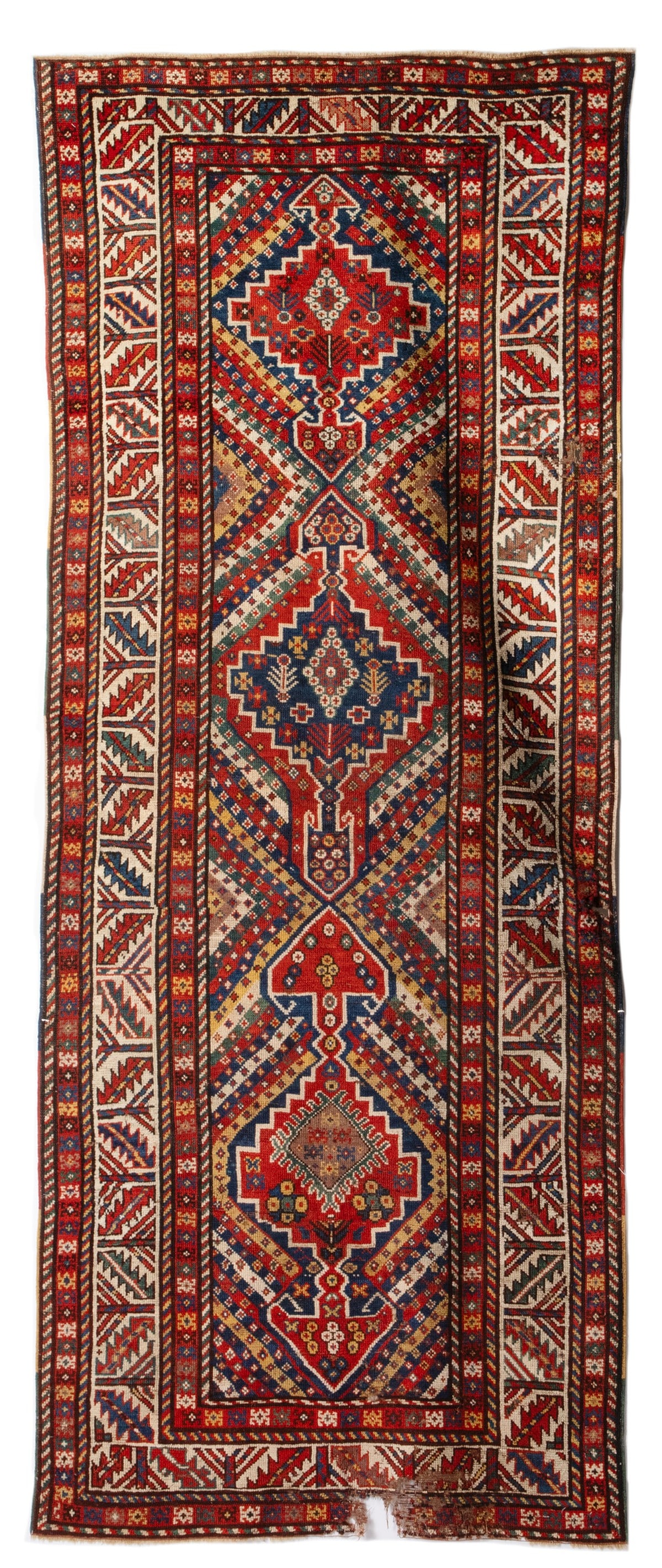 KAZAK RUNNER, WEST CAUCASUS, LATE 19C. AS FOUND DAMAGED: The polychrome diagonal cane banded field enclosing one blue and two red stepped pole medallions within an ivory calyx border. Considerable mothing to the pile throughout. This rug has been stored in 