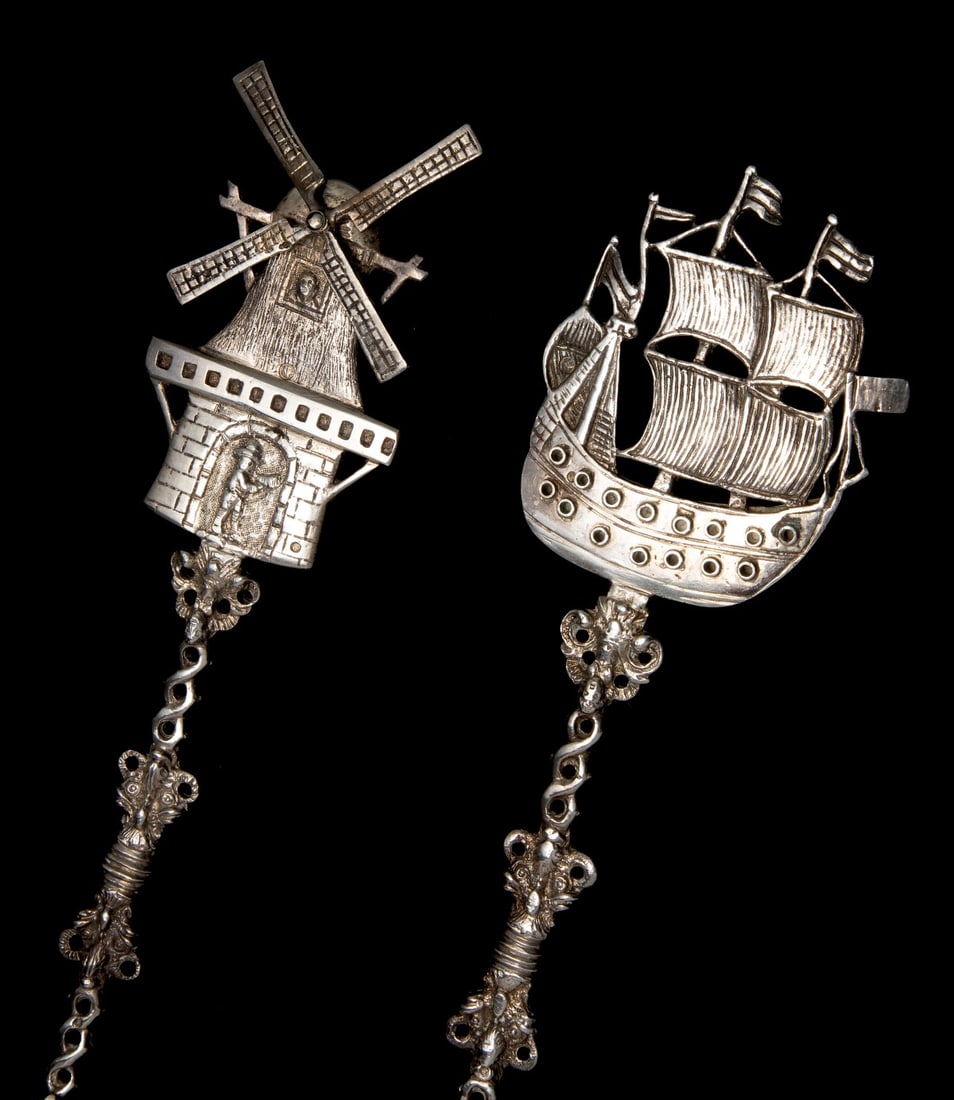 DUTCH .833 SILVER ARMORIAL SPOONS WITH FIGURAL HANDLES: The armorial presentation spoons with engraved family arms backside of each bowl are topped by figural ship and windmill motifs, Each bowl bears the purity mark of .833 silver and the windmill with