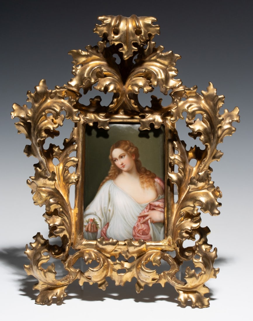 AN EARLY 20TH CENTURY HAND PAINTED PORCELAIN PLAQUE: The 19th-century hand-painted porcelain plaque of 'Flora' after Titian (Tiziano Vecellio 'Titian,' c. 1488-1576) is found in the original Venetian Rococo-style frame. Plaque measures 6 x 4 and the fra