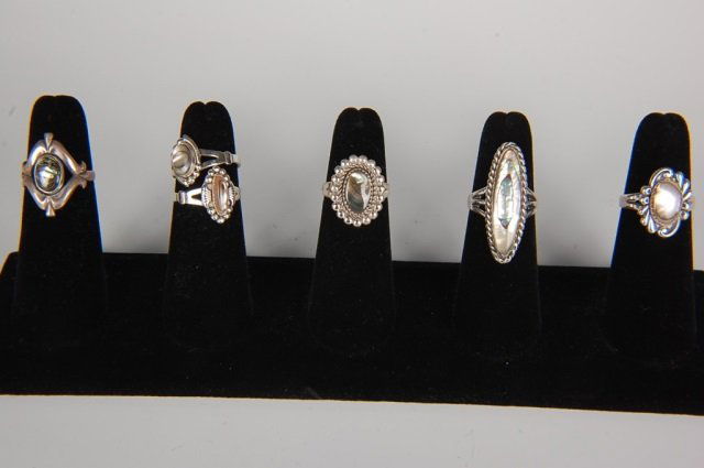 SIX STERLING & ABALONE RINGS BY BELL, SZ 6 TO 6.5: Sterling silver rings with abalone cabochons, all signed Bell and marked sterling. Ring sizes 6 to 6.5. Designs measure from .5 to 1.375 inches.