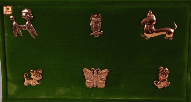 NINE SOLID COPPER BROOCHES BY BELL TRADING POST: Nine pin back brooches in dogs, leaves, owl and butterfly designs, signed Bell and marked solid copper. Measure 1.5 to 2.5 inches.