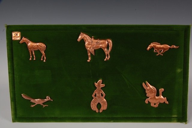 TWELVE SOLID COPPER BROOCHES BY BELL TRADING POST: Twelve solid copper brooches in equestrian and Southwestern designs on two velvet dealer's cards, some are signed Bell and marked solid copper, measure 1.875 to 2.75 inches.