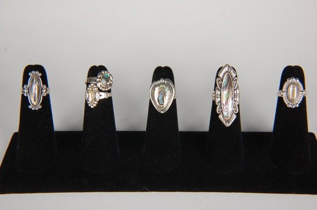 SIX STERLING & ABALONE RINGS BY BELL, SZ 5: Sterling silver rings with abalone cabochons, all signed Bell and marked sterling. Ring size 5. Designs measure from .5 to 1.625 inches.