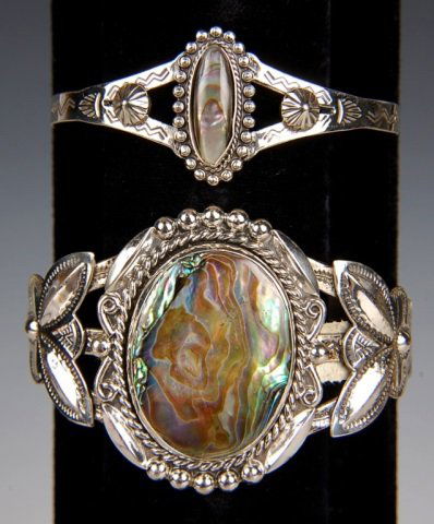 TWO STERLING & ABALONE CUFF BRACELETS BY BELL: Two chased sterling bracelets with polished abalone cabochons. Large bracelet is signed Bell and marked sterling, measures 7 x 1.75 inches. Second bracelet is marked sterling and measures 6.25 x 1 inc