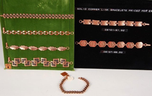 SEVEN COPPER LINK BRACELETS BY BELL TRADING POST: Seven vintage solid copper link bracelets, unmarked. On two display cards with one loose bracelet. Measure 7.5 to 8.25 inches.