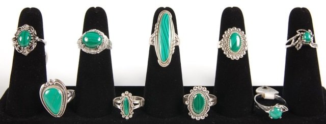 NINE MALACHITE RINGS BY BELL TRADING POST, SZ 6-7: Malachite cabochon rings, five in sterling silver settings, signed Bell Trading Post and marked sterling; one marked 14KT HGE for heavy gold electroplate; and three are unmarked. Sizes 6-7.
