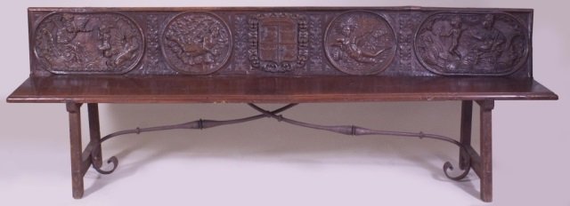 18TH C. HEAVILY CARVED BENCH W/ WROUGHT IRON STRETCHERS: The heavily carved back decorated with five cartouches. Left to right, Saturn (with Zodiacal symbol, and shown devouring a child), next a recumbent Virgo, center with Coat of arms with turrets and lio
