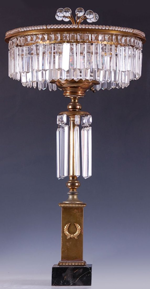 AN ART MODERNE TABLE LAMP WITH MARBLE BASE & PRISMS: Four-socket lamp with brass stem - having wreath applied to one side, on black marble base. Shade with beaded rim, numerous glass prisms. Measures 31.5 x 16 inches.
