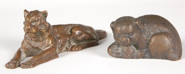 BRONZE LION PAPERWEIGHT, TIFFANY STUDIOS NEW YORK: A bronze recumbent lion marked Tiffany Studios, New York and numbered 932, measures 1.75 x 5 inches . Plus a bronze figure of a dog marked Tiffany Studios, measures 1.5 x 2.75 inches.
