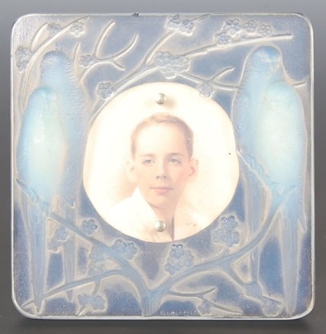 R. LALIQUE OPALESCENT FRAME WITH LOVEBIRDS: Typically found with a clock movement, this piece has the engraved R. Lalique mark and measures 4.25 x 4.25 inches.