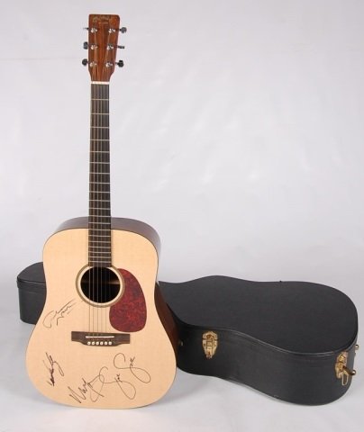 MARTIN GUITAR SIGNED BY CROSBY, STILLS, NASH & YOUNG: A Martin DXBR Dreadnought model numbered 703301 with the original invoice and care instructions - and signed by Steven Stills, David Crosby, Graham Nash and Neil Young. Included with this lot is a SPE