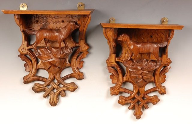 PAIR BLACK FOREST CARVED WALL SHELVES WITH DOGS: With 3-dimensional carved figures of a dog on a rocky base. Each measures 11.75 x 9.5 inches.
