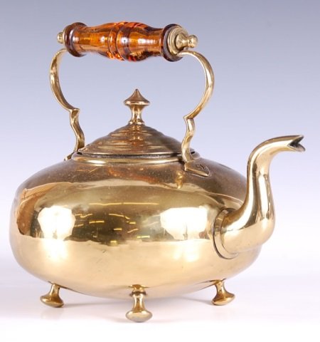 ANTIQUE BRASS ENGLISH TEA KETTLE WITH AMBER GLASS: Impressed with the marks J. C. R. and two arrows, measures 8 x 10 inches.