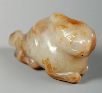 CARVED HARDSTONE FIGURE OF A MYTHICAL QUADRUPED: A crouching figure that measures 1.25 x 2.5 inches.