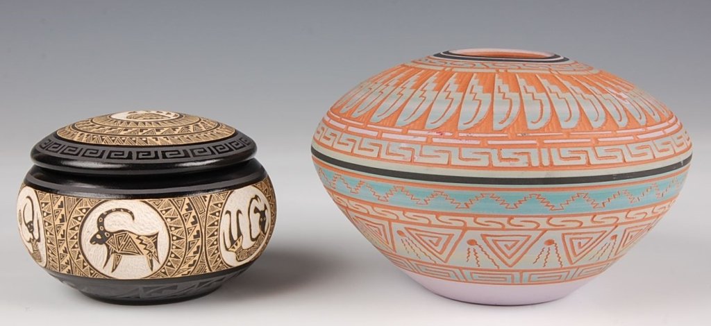 TWO PIECES OF CONTEMPORARY NATIVE AMERICAN POTTERY: A carved seed jar with feather designs, signed Dennis Charlie measuring 3.5 x 5.25. Plus a carved Marvin Blackmore pot with lid measuring 2.25 x 3.75 inches.