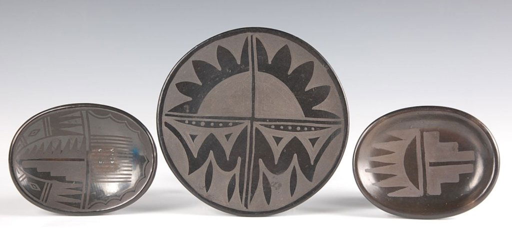 BLACK ON BLACK POTTERY PIECES, SANTA CLARA & SAN: Including a 6.5 inch plate signed Olaria Sisnerios, a 4 x 5 inch oval plate signed Rose and a 4 x 5 inch oval plate signed Blue Corn San Ildefonso.
