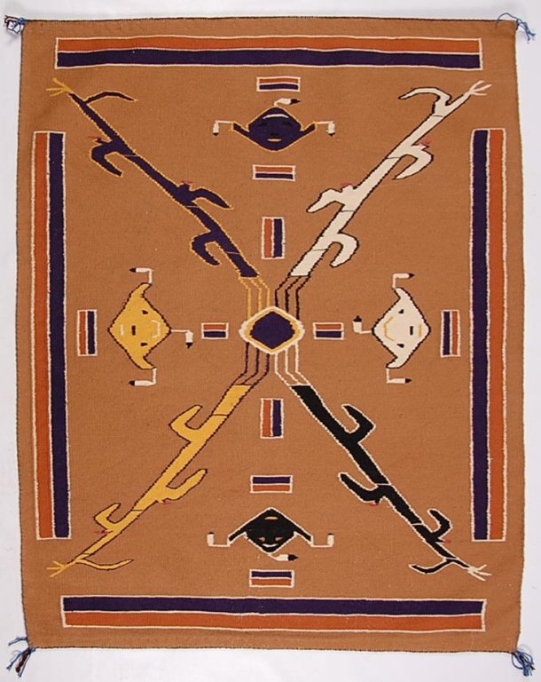 IRENE KELLY SAND PAINTING INSPIRED PICTORIAL NAVAJO: Four Yei masks within figural cornstalks in an interesting balanced design. Measures 41 x 50.5 inches, retains a tag with the makers name and a date of 1972 with a confirmation that the weaving is tru