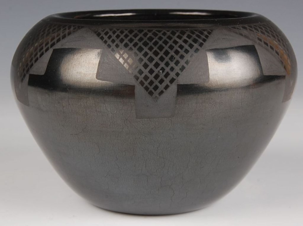 JUAN TAFOYA SAN ILDEFONSO POTTERY: Signed under the base with a date of 1983. Measures 3.5 x 5.5 inches.