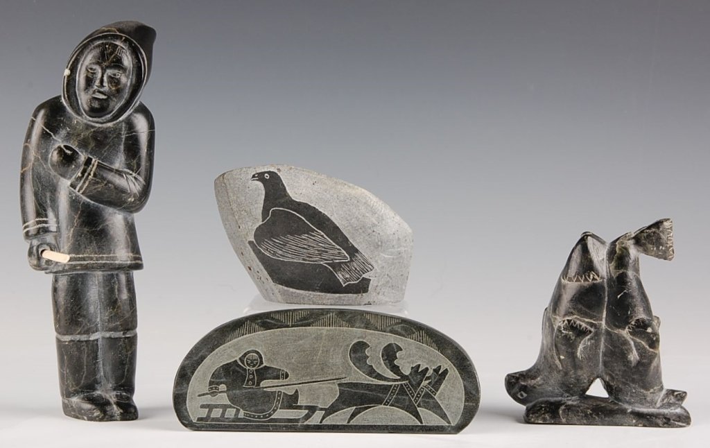 FOUR ESKIMO SOAPSTONE ITEMS: Including two figural pieces and two etched pieces. Sizes range from 4.5 to 8 inches.