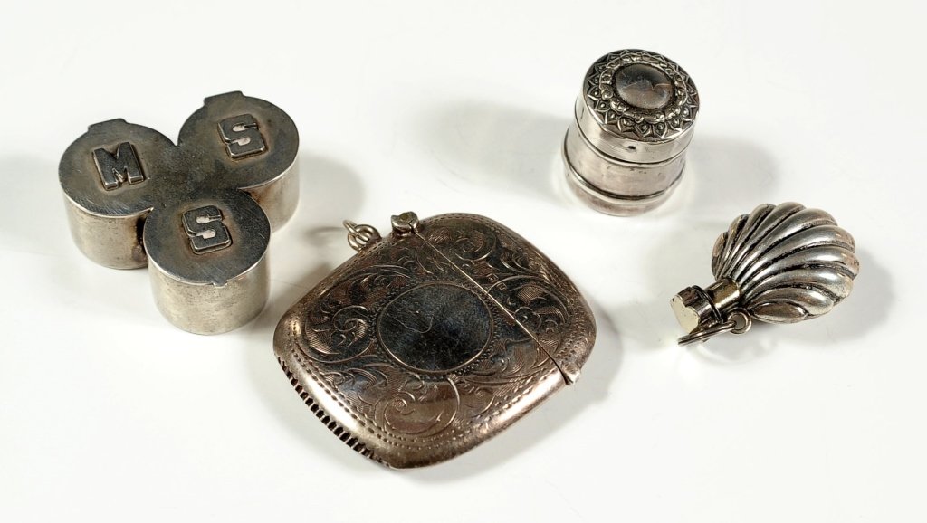 FOUR STERLING SILVER ITEMS: Including a Birmingham match safe with complete hallmarks, a shell form scent bottle with no markings found, a three compartment box by O. Aaroe handmade sterling, and a circular barrel shaped contain