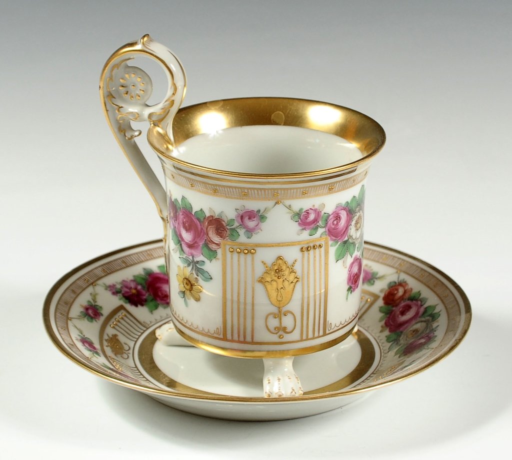 CONTINENTAL PORCELAIN EMPIRE STYLE CABINET CUP SAUCER: Very fine set with paw footed cup on a deep saucer, blue under glaze markings, fully hand painted florals without transfer or decal, gold enamels in relief. Cup measures 4.5 x 4.25 inches at handle, a