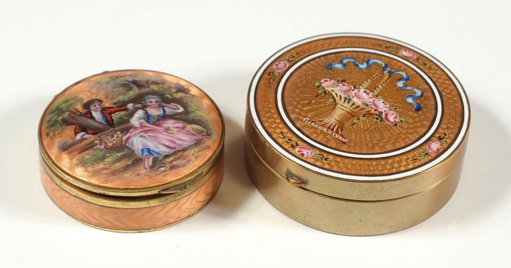 TWO NICE ENAMELED COMPACTS: The larger with guilloche enamel and hand painted florals including basket with ribbon; the other with a courting scene on guilloche enamel. Smaller compact measuring .50 x 2 inches, and the larger co