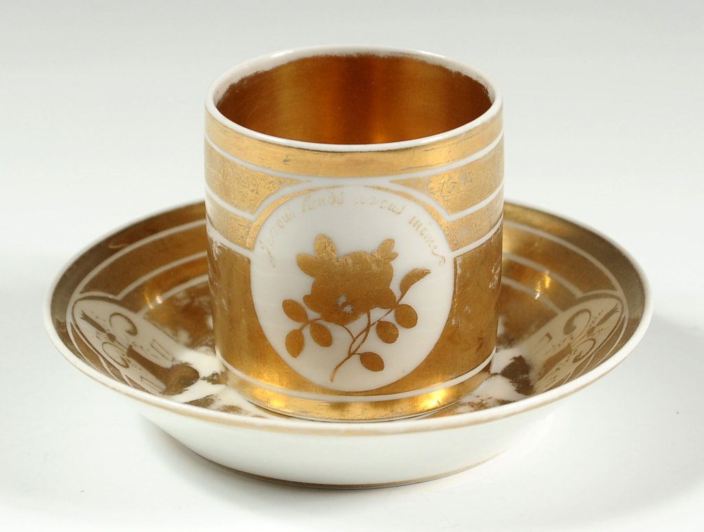 19TH C. FRENCH PORCELAIN CABINET CUP AND SAUCER SET: Empire style influence. Cup measures 2.5 x 3.75 inches including handle, and saucer measures 1 x 5.25 inches in diameter.