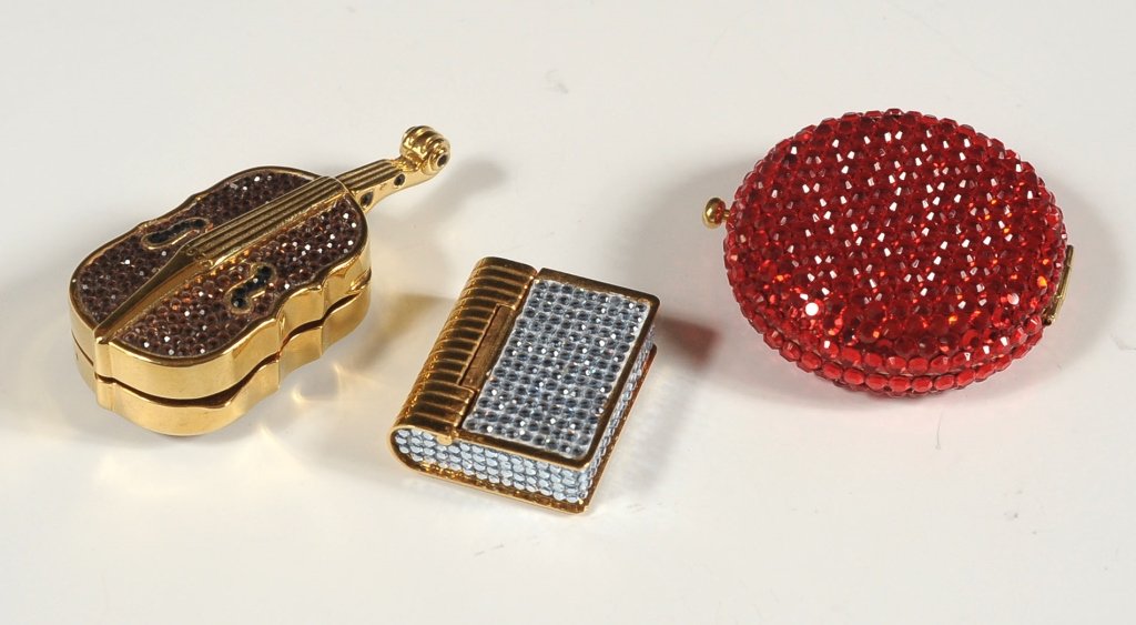 THREE JUDITH LEIBER AUSTRIAN CRYSTAL PILLBOXES: Including cello pillbox, book form pillbox, and red compact.