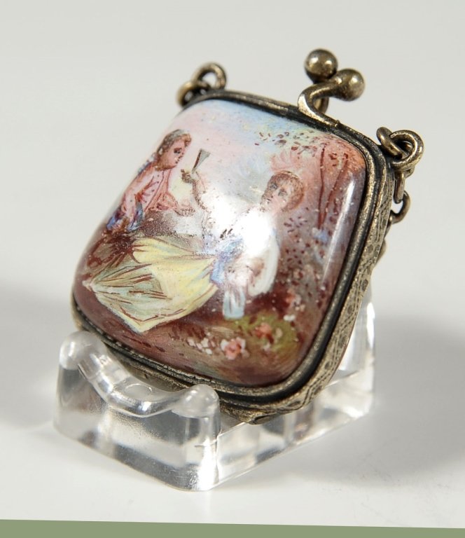 VIENNESE ENAMEL AND SILVER MINIATURE PURSE CHARM: A tiny example with hand engraved bezel and original folded cloth interior. No markings found. Measures approximately 1.25 x 1 inch.