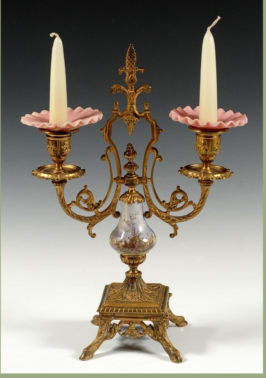 ORMOLU TWO ARM CANDELABRA WITH VIENNESE ENAMEL: Four hoof feet on the square base and a central bulbous stem with hand executed Viennese enamel work of lovers in 18th century dress. Measures 13.25 x 9.75 inches.