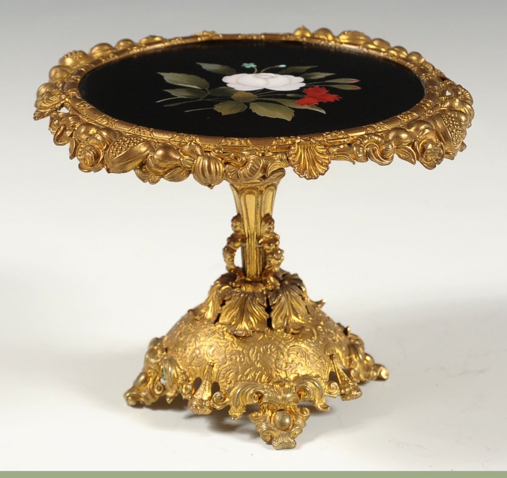 MINIATURE ORMOLU CENTER TABLE WITH PIETRA DURA TOP: A fine gilded metal center table with inlaid slate top set with semiprecious stone in the pietra dura technique. Measures 4 x 5.25 inches.