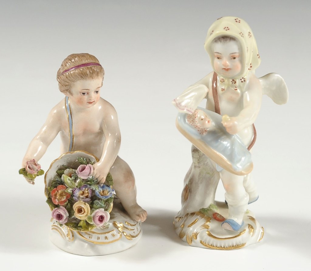 TWO SMALL 19TH CENTURY MEISSEN PORCELAIN FIGURES: A cherub tends to a swaddled baby in crib, plus a figure of putti with flower basket (minor repairs). Each with blue crossed swords mark under glaze. Two figures, tallest measuring 3.75 x 2 inches, an