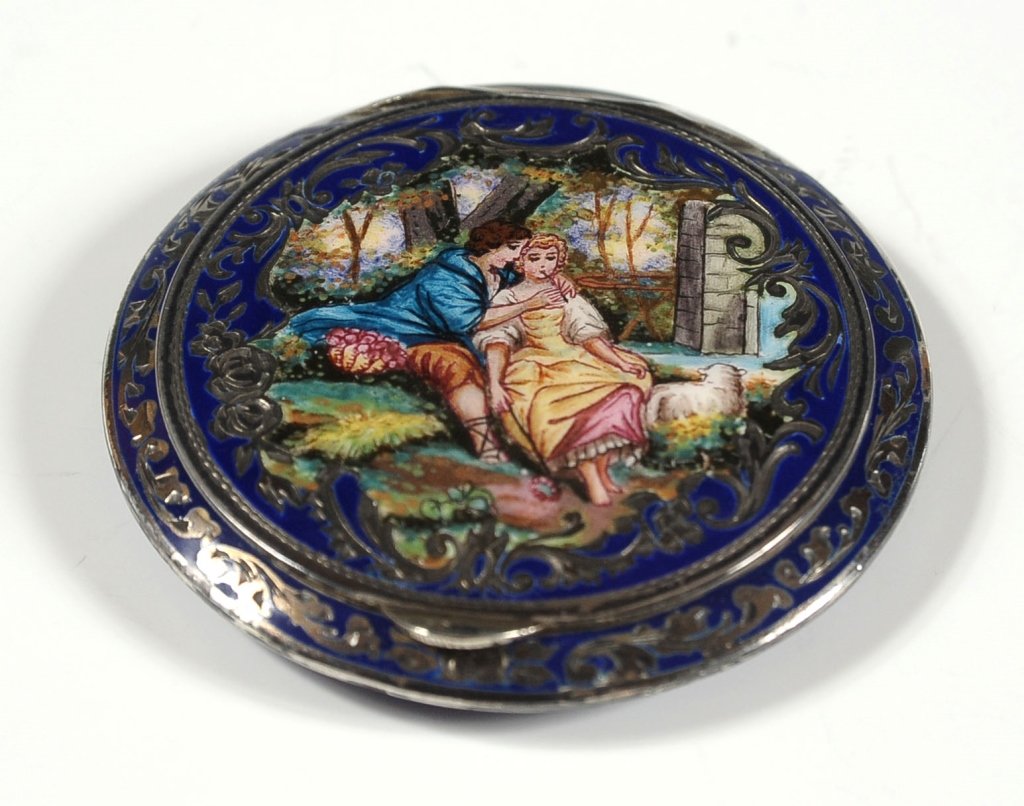 AUSTRIAN ENAMEL ON SILVER COMPACT: With courting scene on the cover , tiny hallmarks on the tab handle. Enameled on all sides. Measures 2.25 inches in diameter.