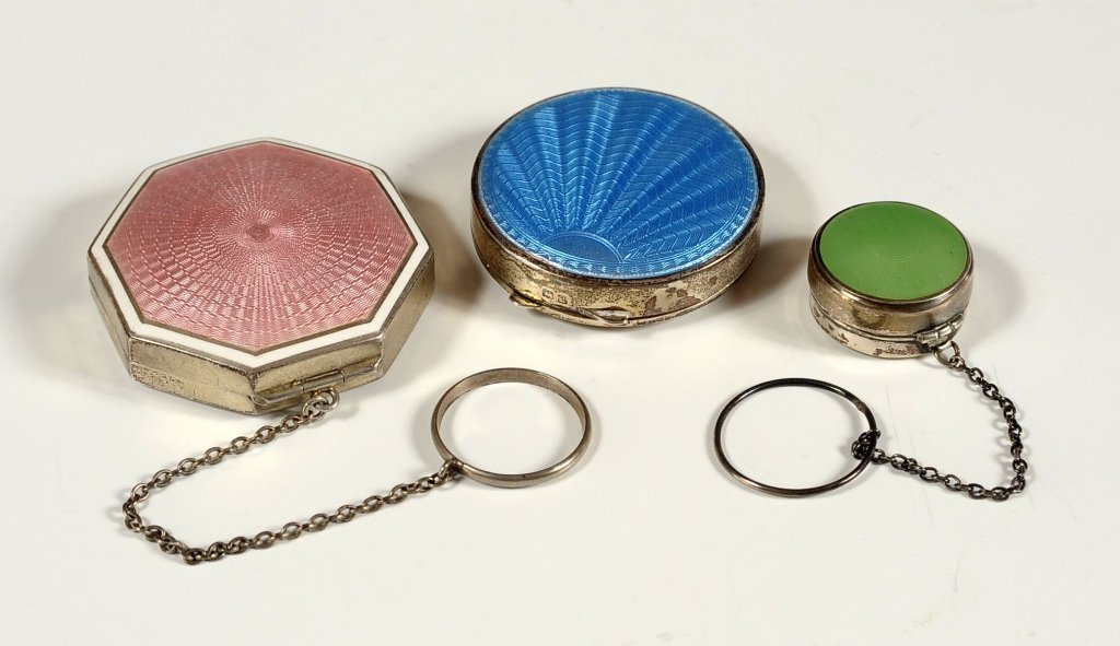 THREE GUILLOCHE ENAMEL ON STERLING SILVER COMPACTS: Including a blue compact with Birmingham hallmarks and two others marked sterling, Sizes range from 2 inches down to 1 inch.