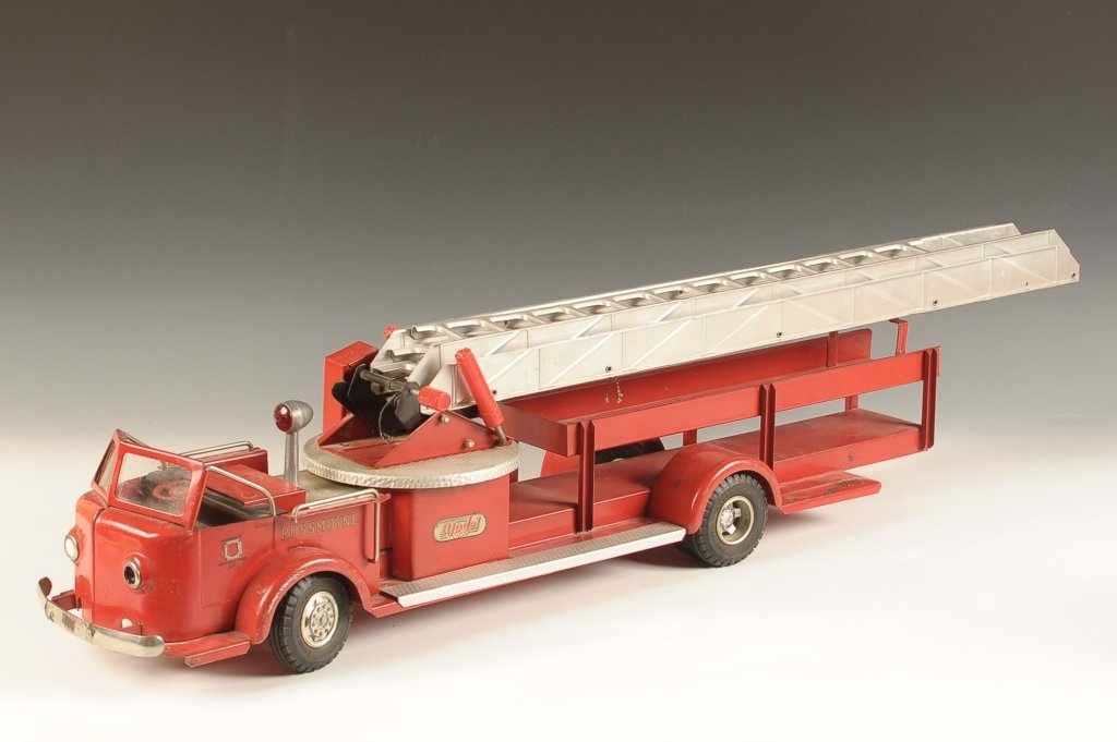 CHARLES DOEPKE MODEL TOYS FIRE TRUCK WITH LADDER: Measures approximately 7 x 7 x 33 inches. Missing a headlight, one loose running board, missing the other.