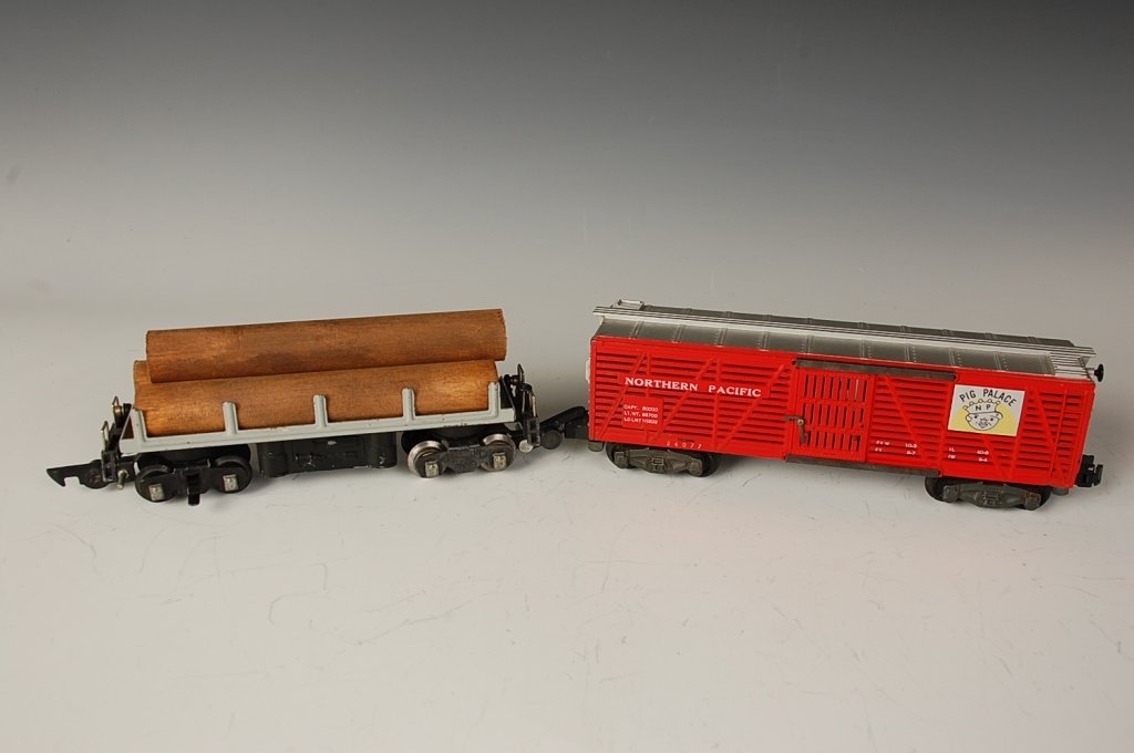 AMERICAN FLYER PIG PALACE 24077 AND LOG CAR: Original 24077 with sliding doors, and an unnumbered log car. All show wear, unknown working condition, average condition.