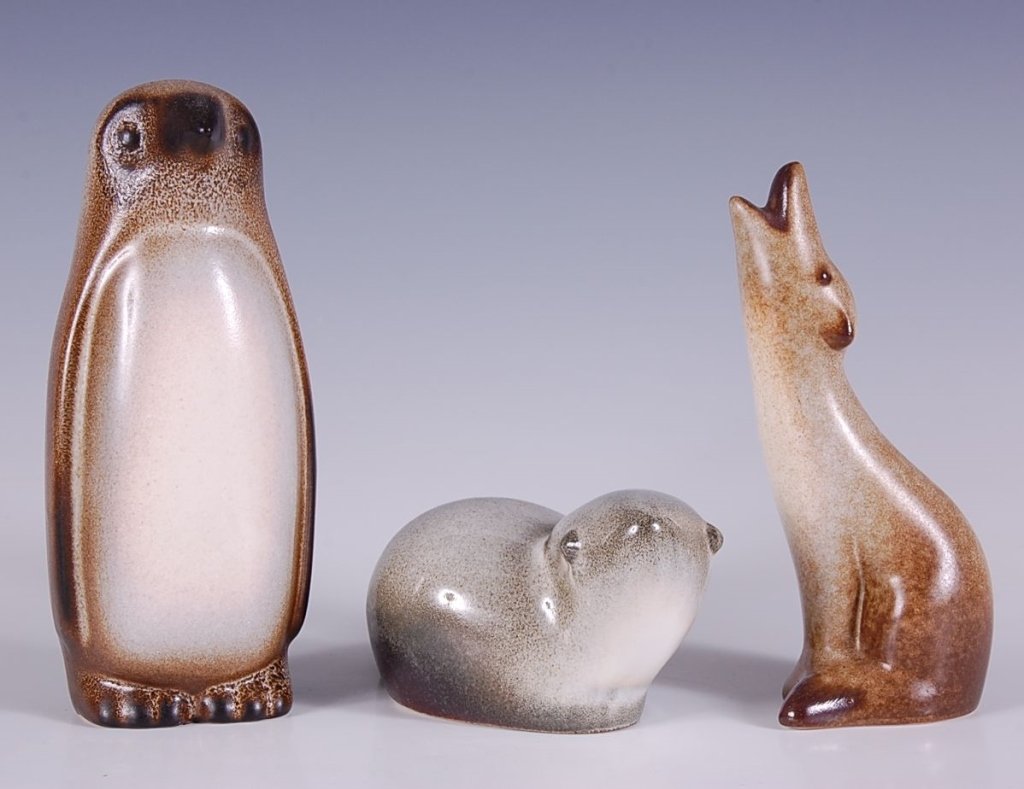 THREE HOWARD PIERCE FIGURES; PENGUIN, WOLF, BEAVER: Penguin signed with black inkstamp, measures 6.5 inches. Wolf with brown inkstamp and hand-signed 'Pierce 1989', measures 5.75 inches. Beaver unsigned, measures 2.5 x 6 inches.