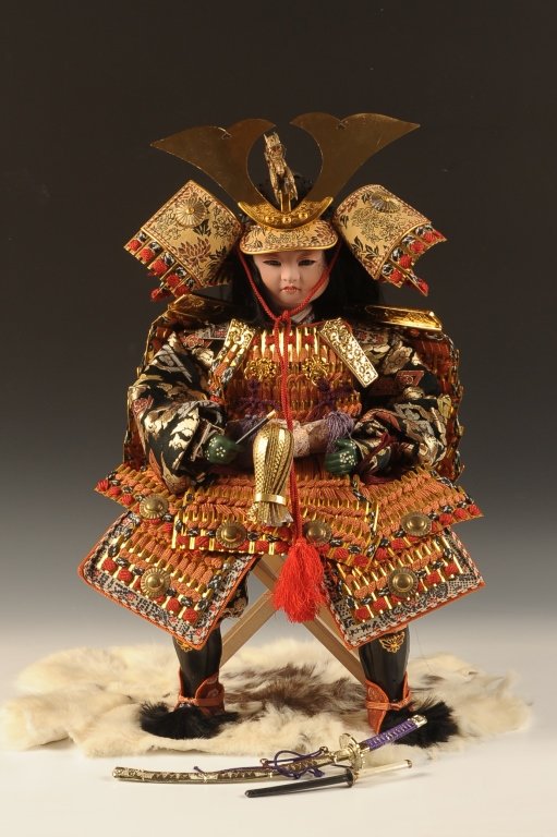 VINTAGE JAPANESE BOY'S DAY SAMURAI DOLL: Circa 1973 mint in the box warrior Samurai doll for Japan's Boy's day (kodomo no hi) celebration, with body armor woven with cords and brocade, kabuto helmet with horns and dragon, composite face and 