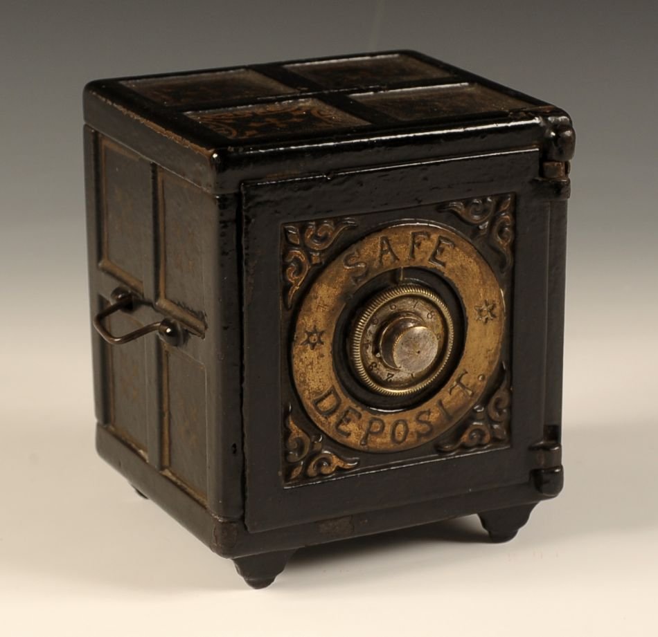 SAFE DEPOSIT' CAST IRON STILL BANK WITH COMBINATION: Henry Chart Manufacturing. All original japanned black finish and stenciled gold decoration. Measures 5.25 x 4.5 x 4 inches.