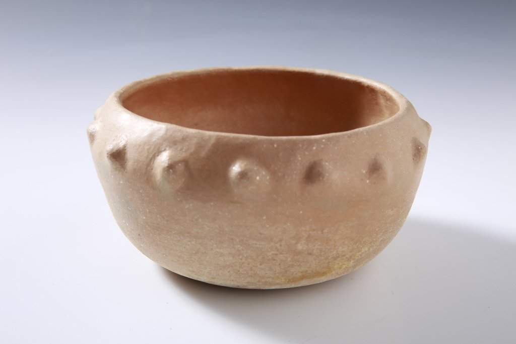 VIRGINIA ROMERO TAOS POTTERY BOWL: An unpainted bowl with raised circular designs, measures 3.75 x 7.5 inches. Signed under the base.