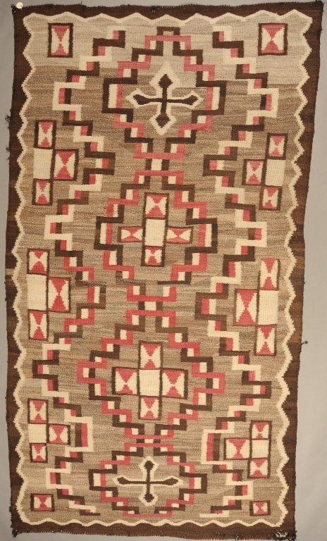A COMPLEX RESERVATION ERA NAVAJO WEAVING: Intricate all-over interlocking step and cross designs. Measures 94 x 52 inches.