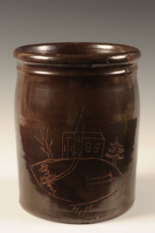 ALBANY SLIP STORAGE JAR WITH ETCHED CHURCH DECORATION: A good 19th C. open crock with Albany slip glaze scratched with a folk art image of a church on a hill. Previously the property of Margaret Pachel, a North Dakota School of Mines potter and art potter