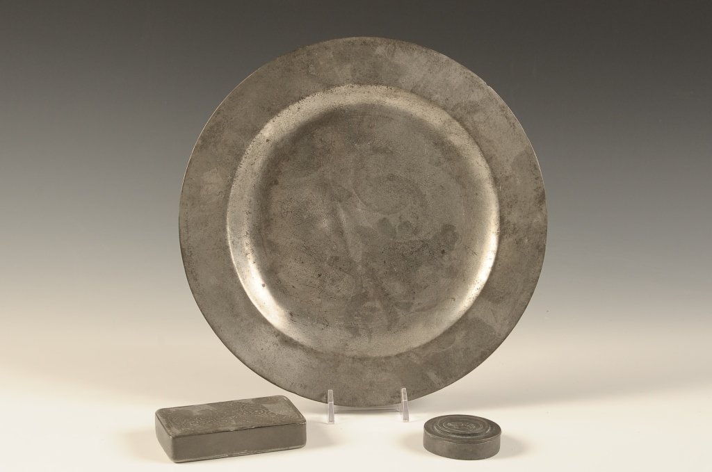 PEWTER PLATE AND TWO PEWTER SNUFF BOXES: Three pieces with the plate that measures 9.25 inches in diameter, small round case measures 1.75 inches and a rectangular case measures 2 x 2.25 inches.