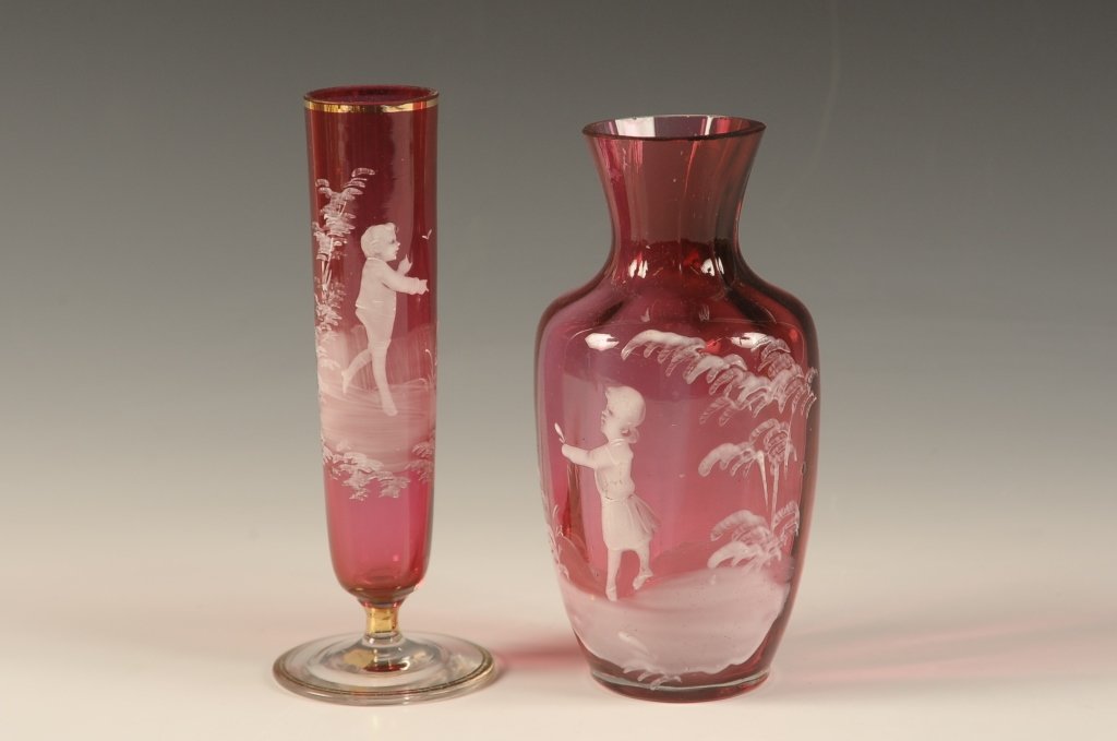 TWO PIECES MARY GREGORY CRANBERRY GLASS: Two pieces with one taller piece that measures 5.75 x 2.25 inches and the shorter piece measures 5.5 x 2.5 inches.