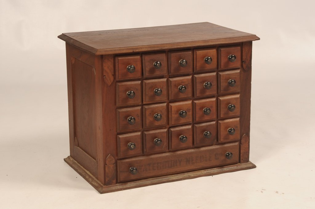19TH C. 20 DRAWER NEEDLE CASE: With faint advertising on the bottom drawer for Waterbury Needle Co. Measures 18.5 x 23 x 14.5 inches.
