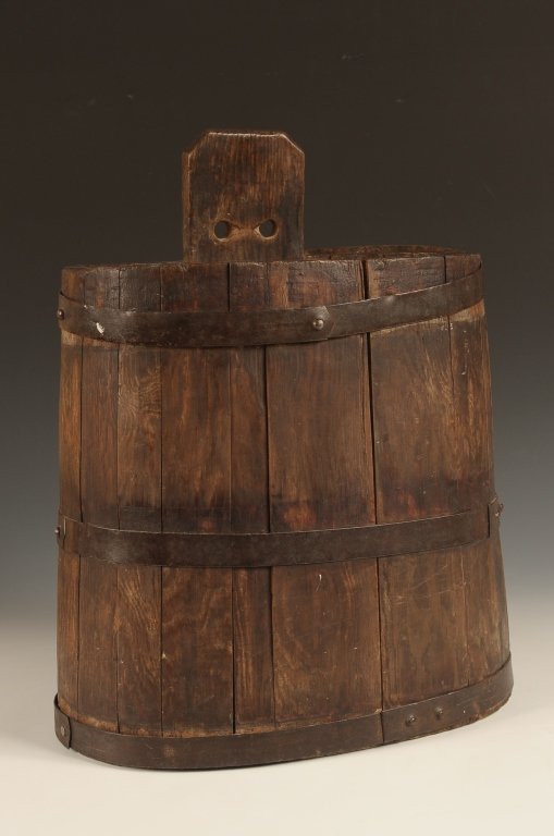 NEW ENGLAND WOOD STAVE VINEGAR BUCKET WITH IRON BANDS: Pine wood and forged iron bands. Neat oval shape. Measures 17.75 x 13 x 7.5 inches.