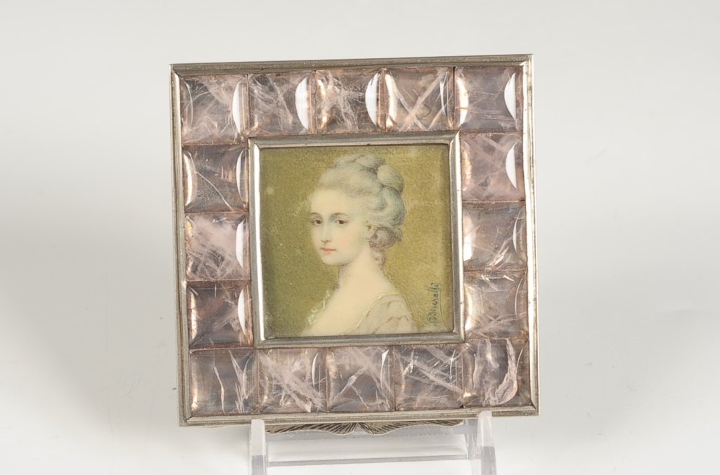 MINIATURE PORTRAIT COMPACT SIGNED 'H. HIERELLI(?)': Miniature portrait of a woman under glass surrounded by lavender square faceted stones, chased silvered base, beveled mirror in the lid, unmarked, measures 3 x 3 inches.