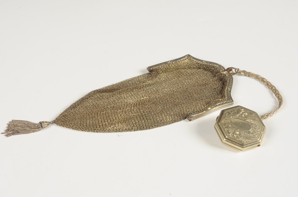 BLISS MESH BAG WITH COMPACT FOB: Bliss mesh goldtone bag with a chased goldtone compact fob on a braided chain, framed mirror in the compact lid, marked on the inside of the bag frame, bag measures 8.5 x 3 inches, compact measures 1.