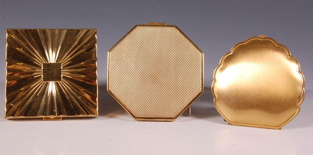 AMERICAN BEAUTY, MAX FACTOR & A VINTAGE COMPACT: Goldtone American Beauty by Elgin American compact in a stylized heart shape, framed mirror in the lid, hinged powder well, shaped and branded puff, marked on the powder lid, measures 3 x 2.75 inches,