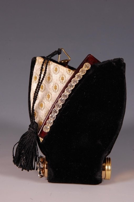 ZELL FIFTH AVE. VANITY SET IN A VELVET CLUTCH: Zell Fifth Avenue black velvet and cream and gold brocade carrying case in an abstract tulip shape that holds a lipstick with rhinestones on one end, a plastic comb with a rhinestones along the back t